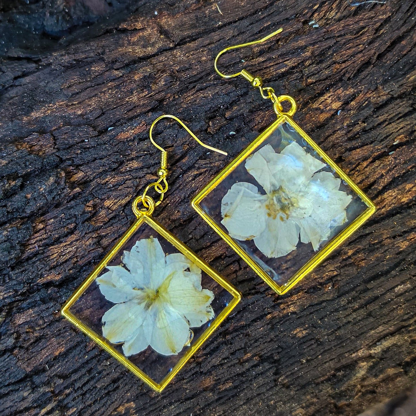 White delphinium earrings set in resin