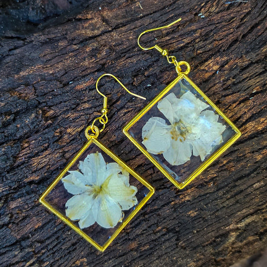 White delphinium earrings set in resin